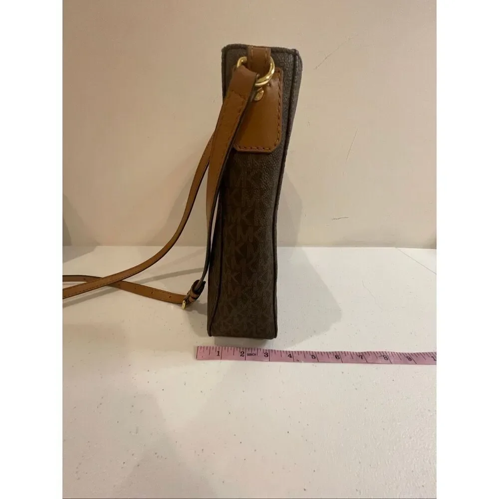 a Michael Kors Jet Set Travel Large Messenger Bag, featuring the brand's signatu